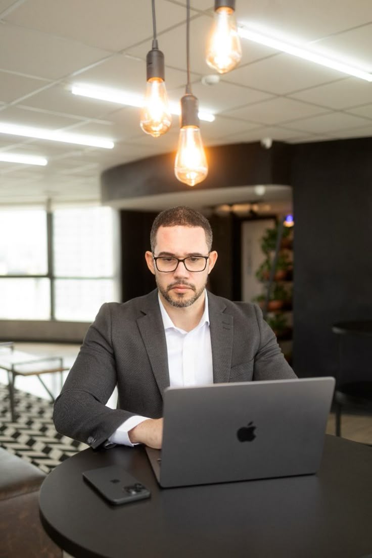 Prompt 18 — Professional executive working on a laptop in a modern office loung...